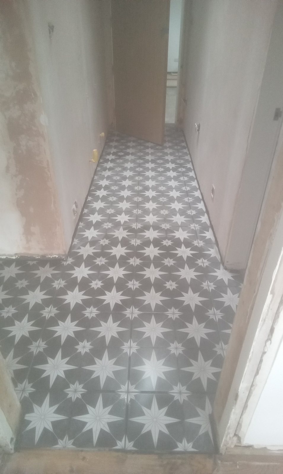 Finished patterned hallway floor tiling in Airdrie by Herringbone of Lanark