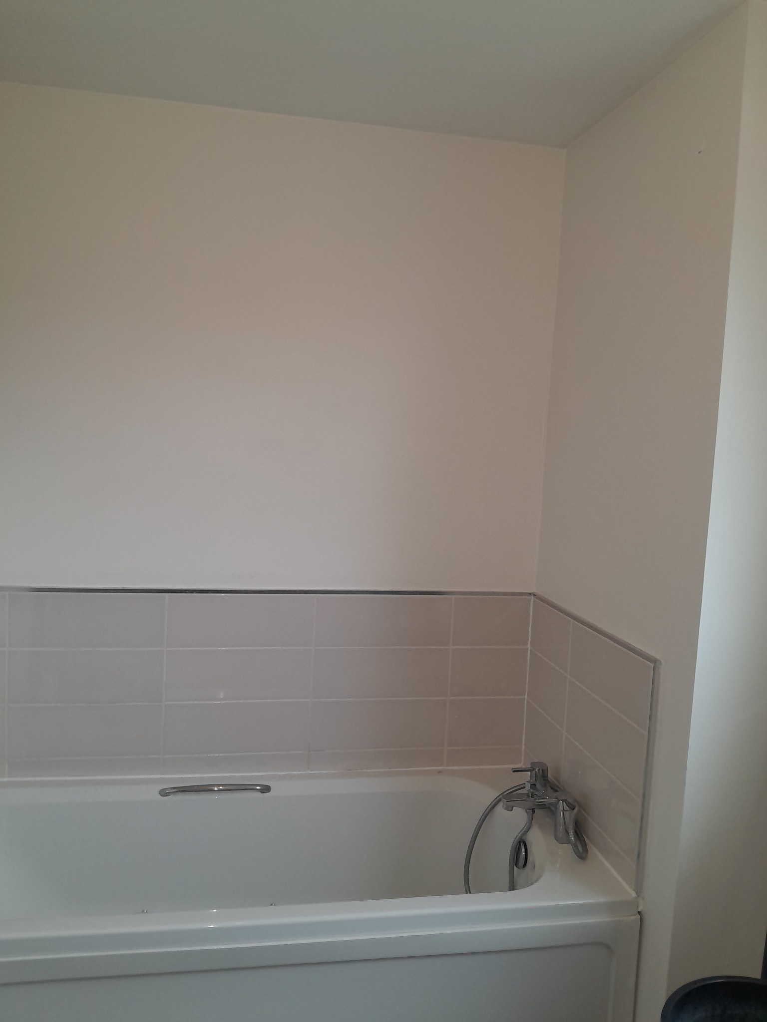 Bathroom wall before large-format tiles were installed in Bathgate