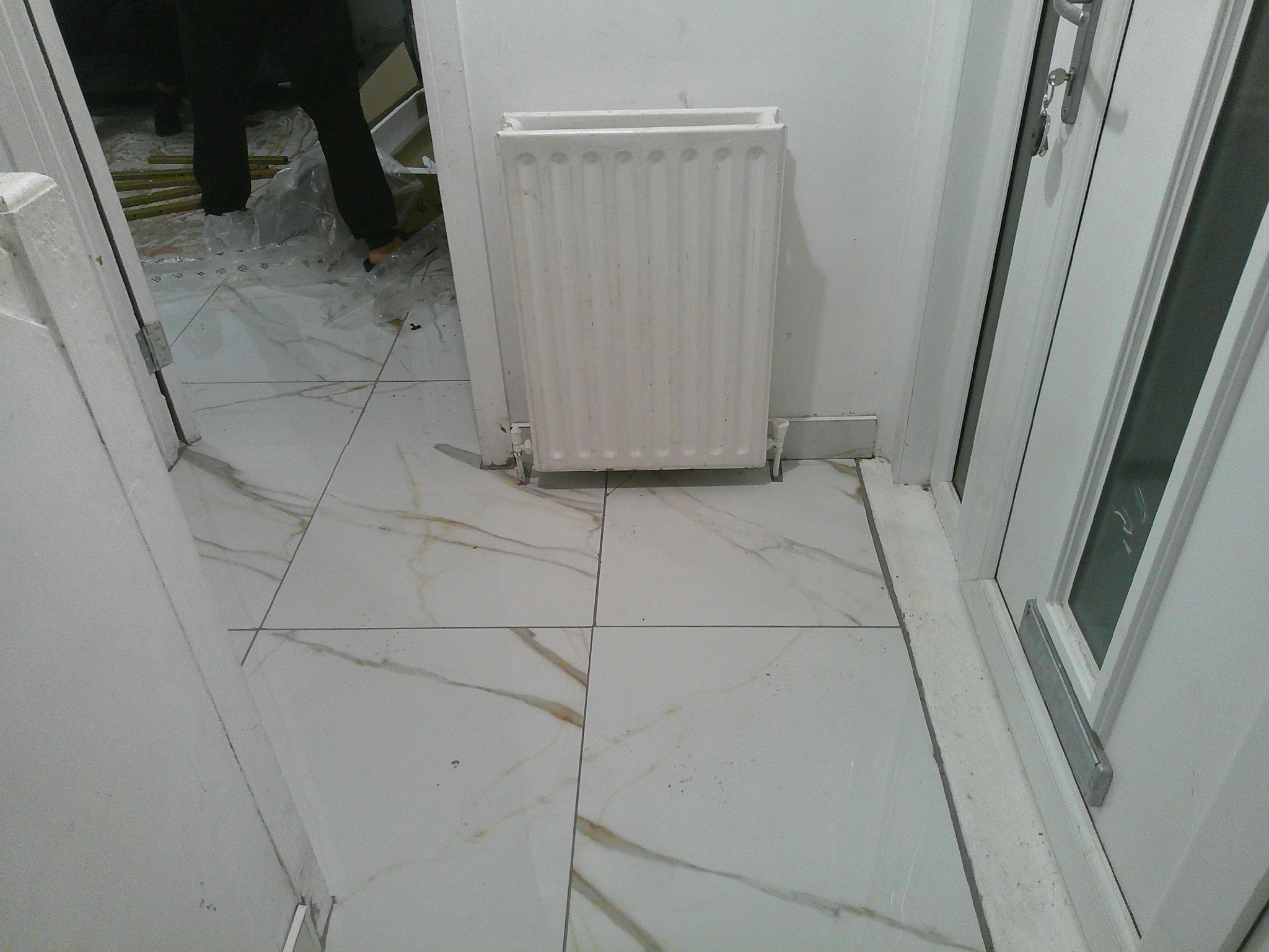 Finished marble-effect tiled entrance by Herringbone of Lanark