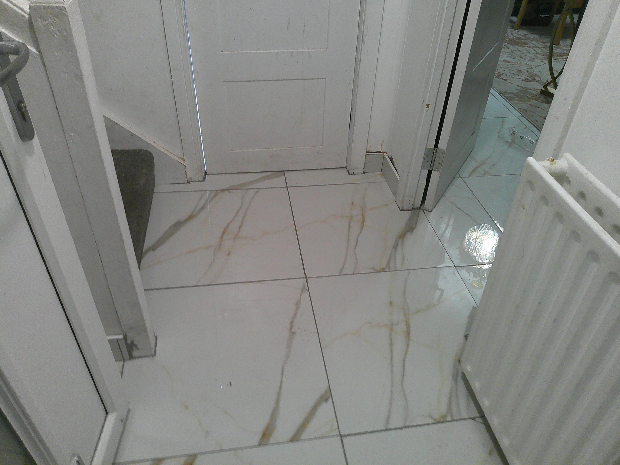 Completed marble-effect hallway floor tiling