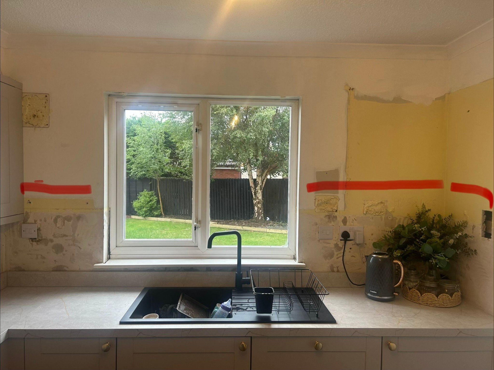 Kitchen wall before tiling around the sink and window