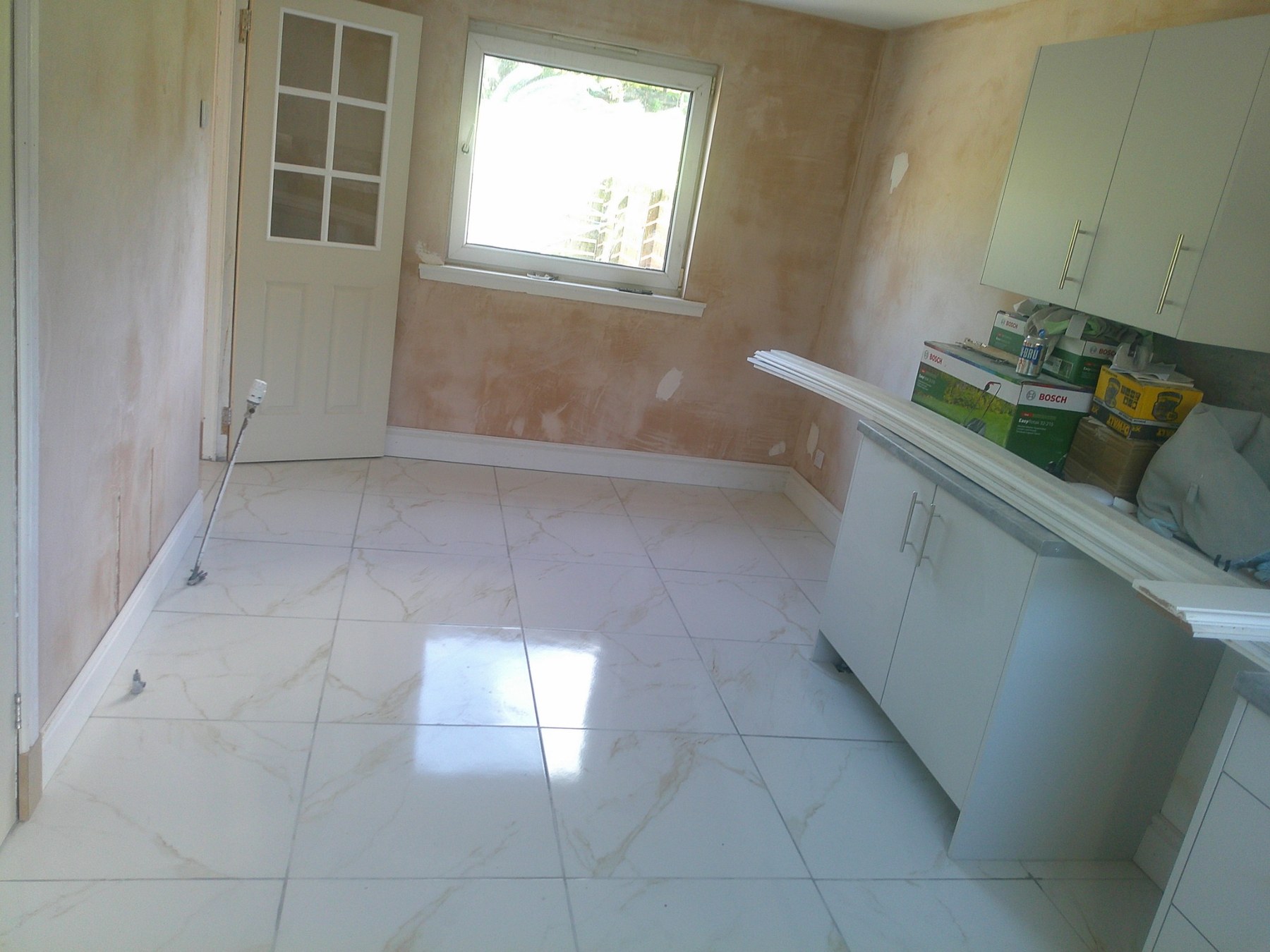 Continuous large-format tiled hallway in East Kilbride by Herringbone of Lanark