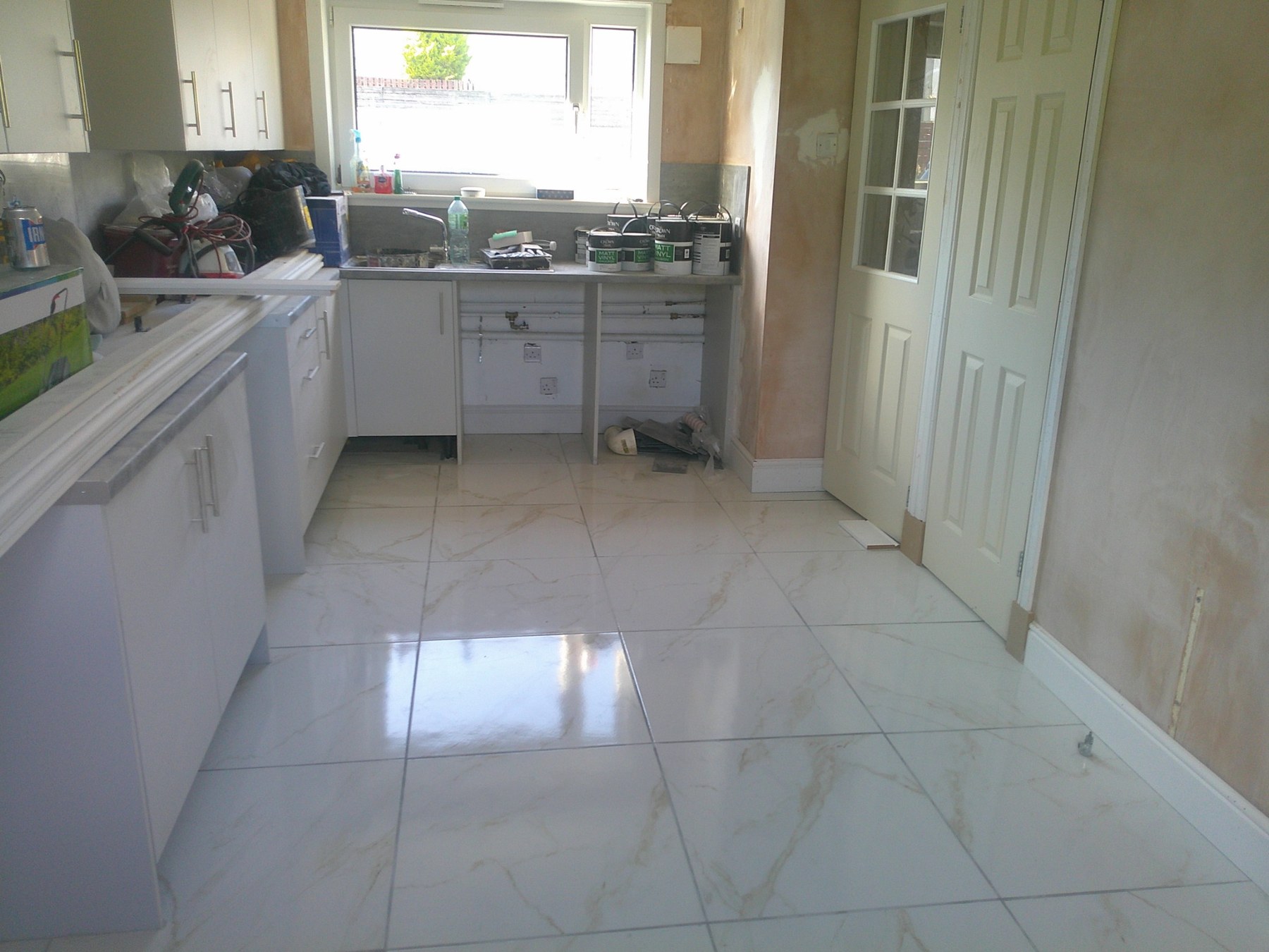 Large-format marble-effect kitchen floor tiling in East Kilbride by Herringbone of Lanark