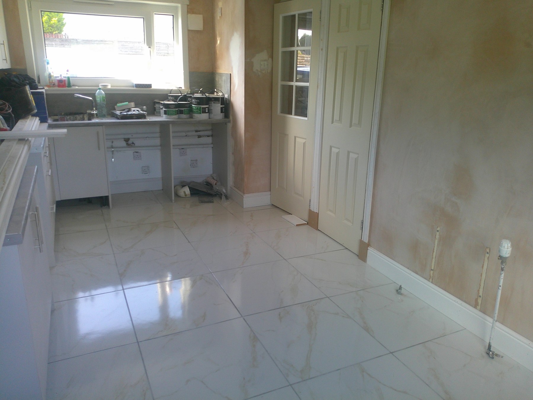 Finished marble-effect tiled kitchen floor in East Kilbride